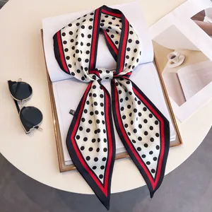 Polka dot silk scarf with red and black borders styled with sunglasses and a magazine