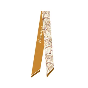Detailed close-up of a double-sided silk scarf featuring ochre and marble fluid patterns