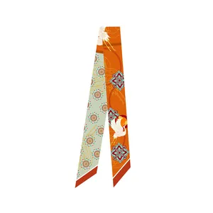 Detail of Dunhuang style silk scarf with crane and floral patterns on orange and cyan satin