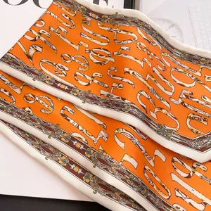 Vibrant orange silk scarf with abstract letter prints for women's fashion styling