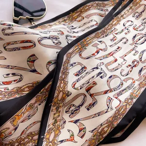 Detailed view of the elegant baroque pattern and smooth silk fabric of this scarf