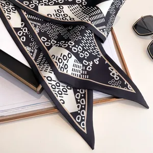 Elegant black and white silk scarf with 1010 pattern and stylish sunglasses display
