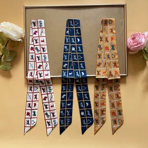 Detailed view of three equestrian silk twilly scarves with horse and stirrup patterns