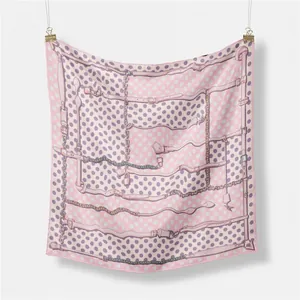 Detail of pink and white square silk scarf with vintage chain and polka dot patterns