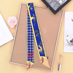 Detailed view of silk twill skinny scarf with vintage carriage and blue geometric patterns