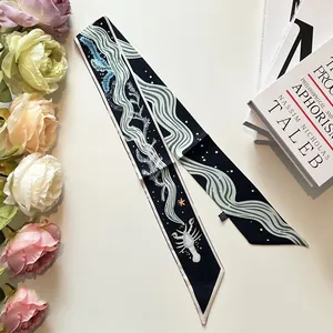 Double-sided slim silk scarf with navy lobster and sea wave patterns on white desk