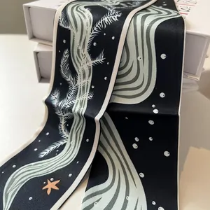 Detailed shot of dark blue narrow silk scarf with starfish and seaweed ocean patterns