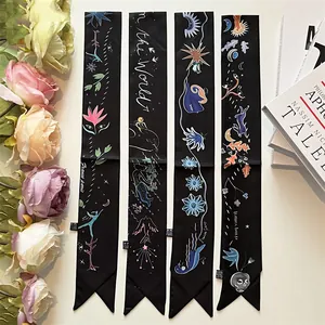 Elegant black silk-like skinny twilly scarves with artistic prints and floral accents
