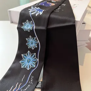 Detail of black silk twilly with blue sunburst print and France Paris lettering
