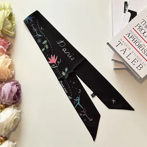 Detail of a black silk twilly with colorful Paris art graffiti and artistic patterns