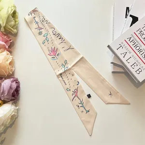Elegant cream silk twilly scarf with artistic floral and moon patterns for handbags