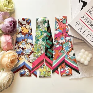 Three vibrant floral silk handle scarves with vintage patterns and geometric designs