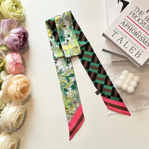 Close-up of double-sided twilly silk scarf with floral and geometric patterns