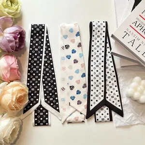 Three elegant long narrow silk scarves with polka dots and heart patterns for women
