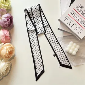 Polka dot skinny silk scarf in black and white geometric pattern for summer styling