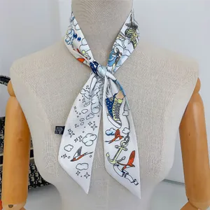 Close-up of vibrant nautical and wing motifs on a slim polyester scarf for bags