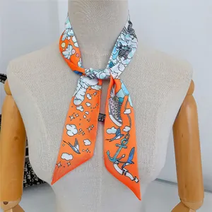 Detail of a thin silk scarf styled on a mannequin with bright orange nautical patterns