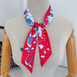 Detail of red twilly scarf with cartoon illustrations tied on model's neck for styling