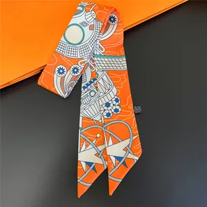 Narrow silk twilly with orange and blue space-themed patterns for handbags and neckwear