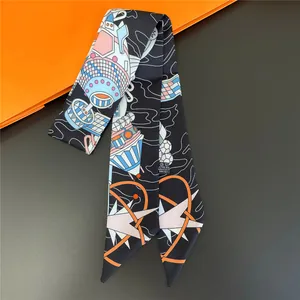 Macro shot of narrow silk-like scarf with spaceship print and geometric galaxy patterns