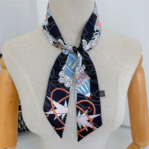 Detailed close-up of navy blue skinny scarf with cosmic geometric patterns on mannequin