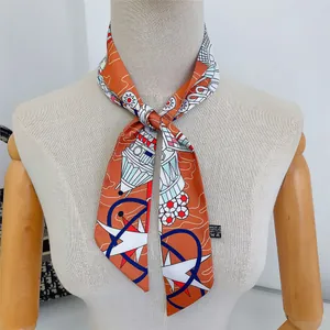 Detail showing high-quality silk twilly scarf with nautical patterns on a mannequin