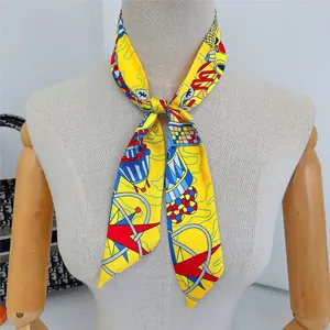 Detail of a bright yellow geometric silk twilly scarf tied on a mannequin neck
