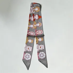 Detail of grey silk scarf featuring vintage Egyptian and robot illustrations for women