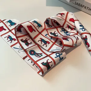Close-up of equestrian silk twilly with horse pattern and classic plaid weaving