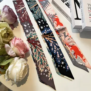 Detailed view of three luxury silk skinny scarves with jungle and star motifs and roses