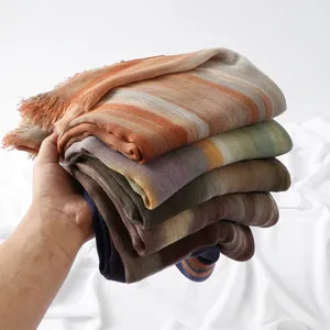 Detailed shot of multi-color striped cotton scarves with soft fringe edges and texture