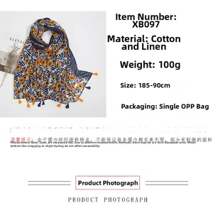 Detail of navy blue cotton linen shawl with orange flower print and tassel trim