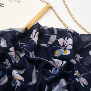 Floral print cotton linen scarf in navy blue with elegant pink blossoms and tassels