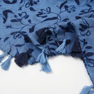 Detail of blue floral print scarf showing cotton linen texture and fringe tassels