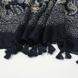 Detail of navy blue paisley cotton shawl with decorative tassels on the edges