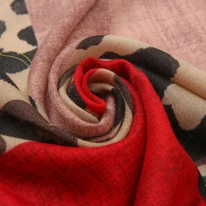 Macro shot of cotton linen scarf showing leopard print and red color splicing texture
