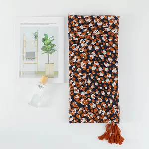 Ethnic orange leopard print cotton-linen scarf with decorative tassels and fringe