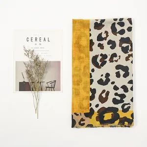 Detailed macro of leopard print scarf with tassels and trendy yellow patchwork design