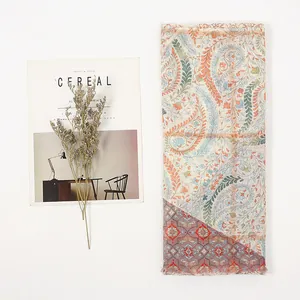 Detail of bohemian paisley print scarf with delicate tassels and artistic decor