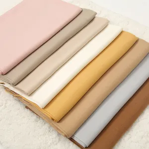 Detail of cashmere-like scarves in multiple solid colors with soft diagonal twill texture