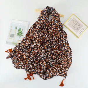 Ethnic orange leopard print scarf with tassels for sun protection and autumn warmth