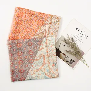 Bohemian paisley scarf with gold leaf print and soft fringe tassels in warm orange and blue