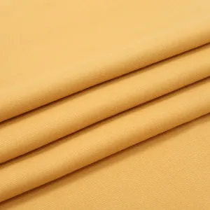 Close-up of thick ginger yellow cashmere-feel scarf showing diagonal twill weave texture