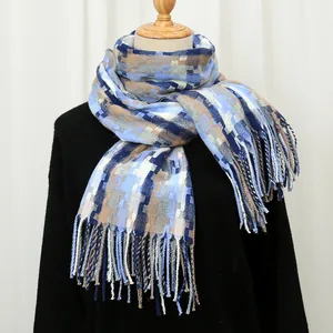 Detail of blue and grey checkered cashmere-feel scarf with long fringe on mannequin