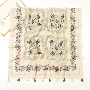 Close-up of lightweight floral cotton linen scarf with olive green tassel fringe details