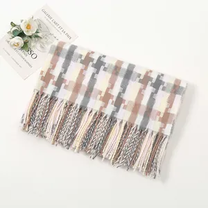 Detailed close-up of soft plaid scarf with fringe tassels and woven mosaic pattern