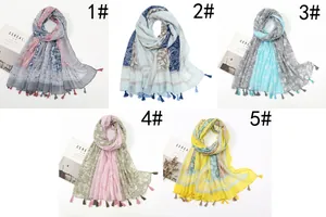 Flat lay of five printed voile scarves with bohemian patterns and fringe edges