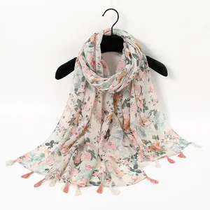 Detailed view of floral pattern and handmade tassels on soft cotton linen shawl