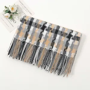 Close-up of winter thick plaid scarf with tassels and elegant decorative props