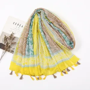 Close-up of yellow Bohemian scarf showing intricate geometric patterns and tassels